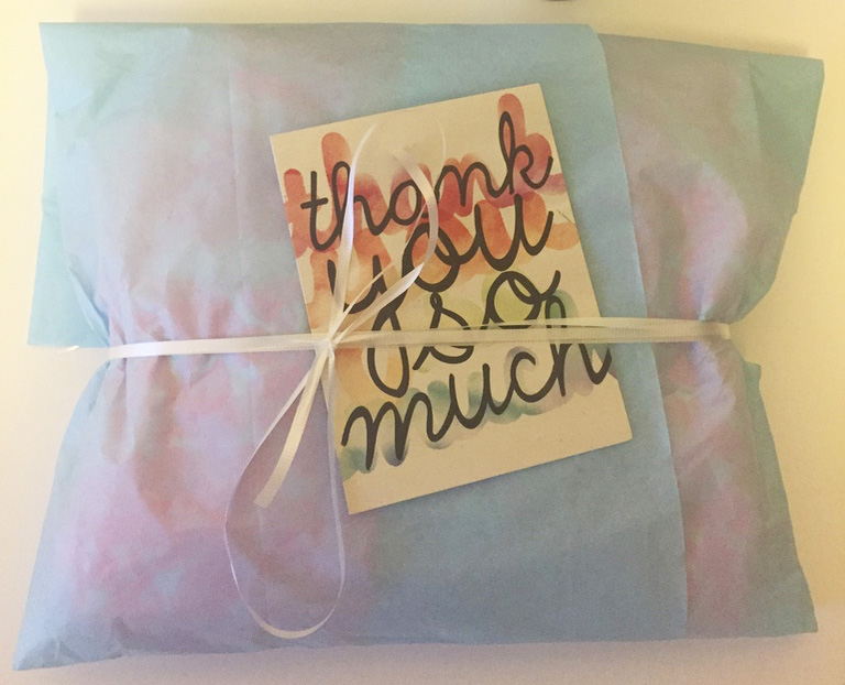 Thank you note and package with ribbon