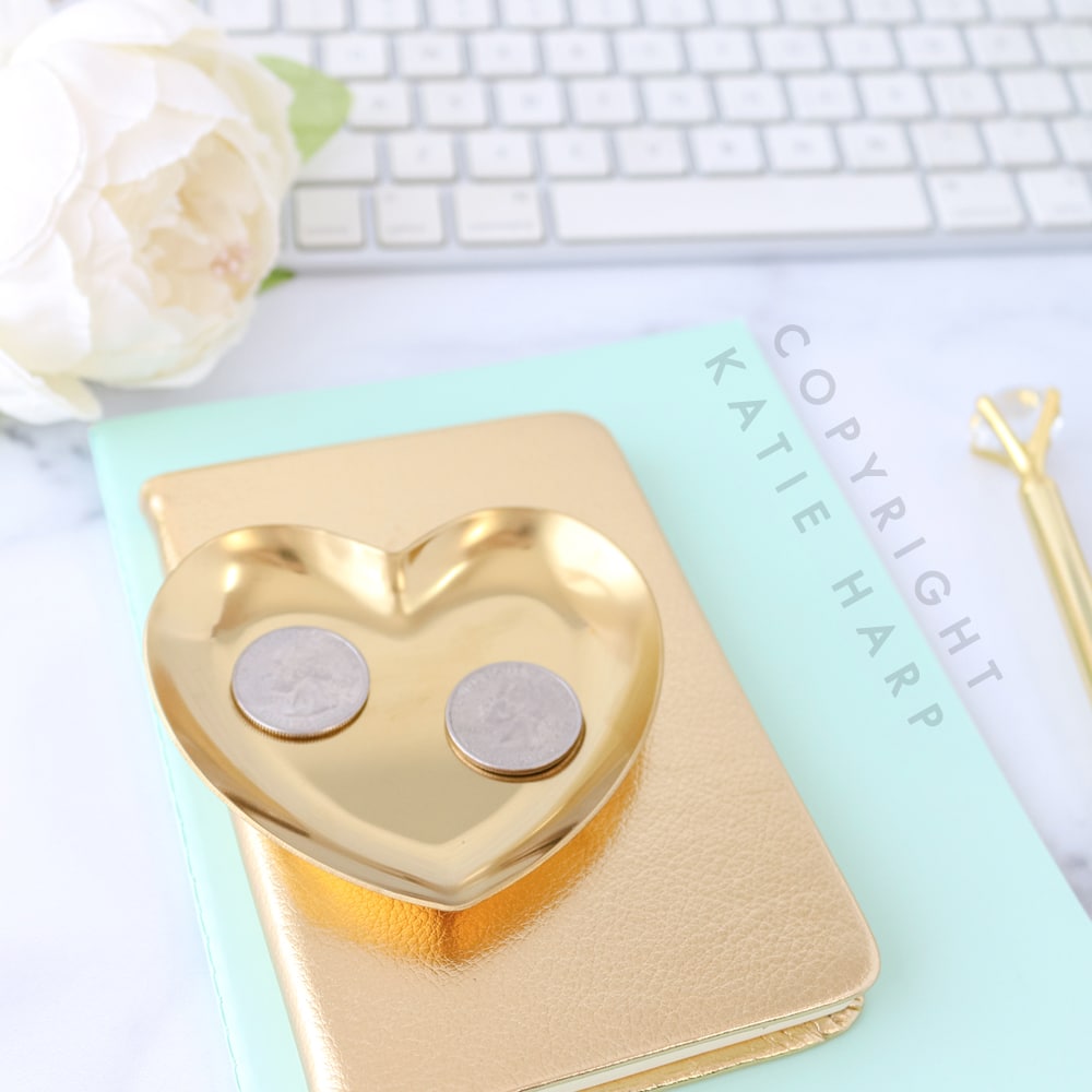 Gold notebook and heart with coins